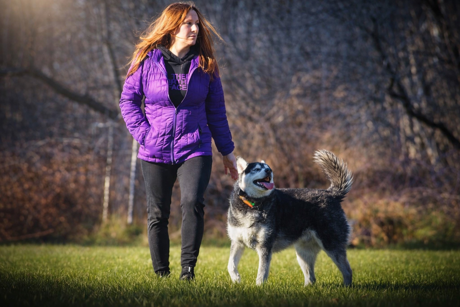 Jeannie Oakley walking with a husky outdoors